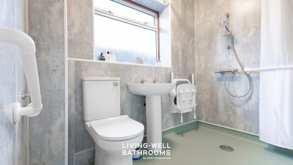 Wet room with green safety flooring, toilet basin, drop down seat, wall panels and shower screen 