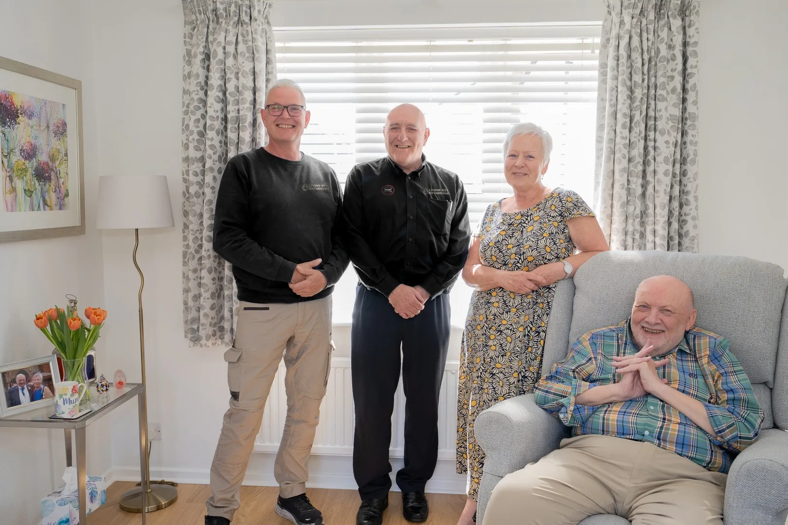 Living Well Bathroom Surveyor and installer standing with customers in their living room