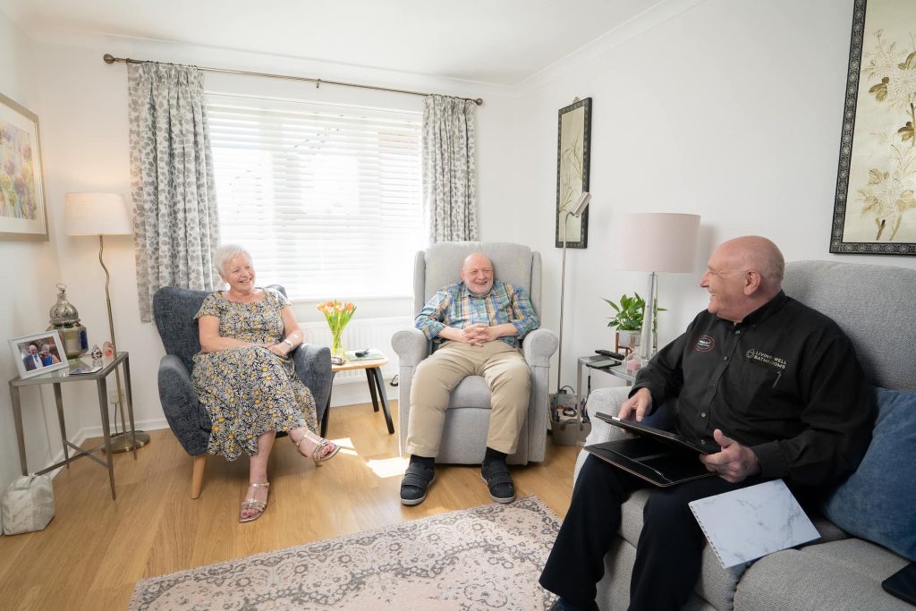 Living well bathrooms home surveyor sat in the living room with an older couple during a home survey