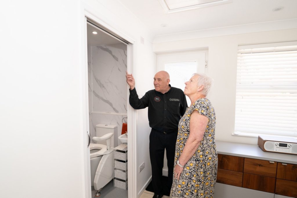 Living Well Bathrooms surveyor showing customer her new bathroom